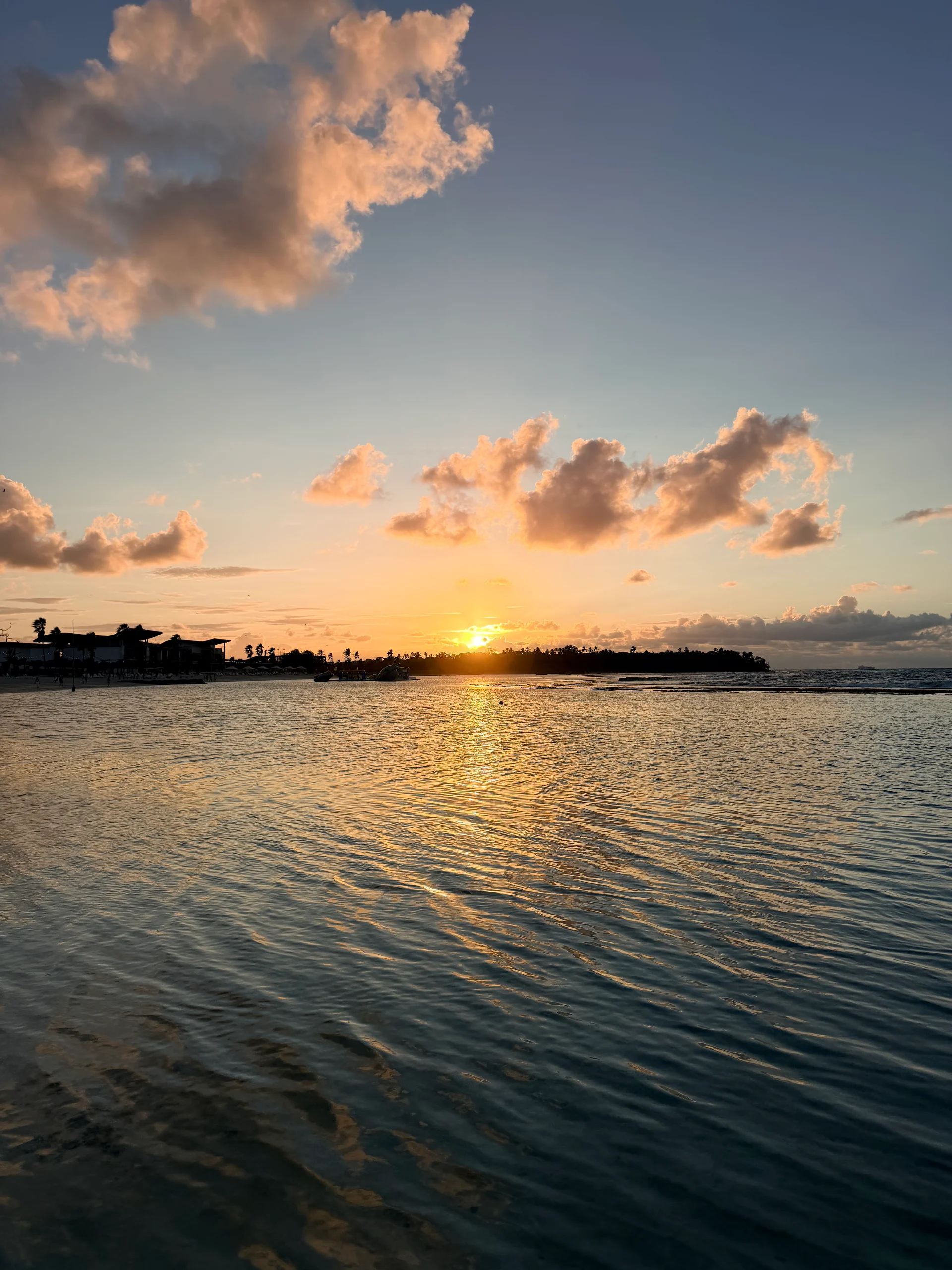 Un coucher de soleil à couper le souffle sur les eaux turquoise paisibles de Playa Escondida, Panama. La chaude lumière dorée se reflète sur les douces vagues, créant une scène sereine et idyllique.